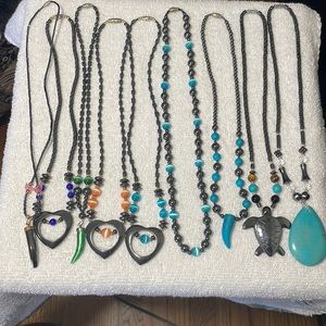 9 beautiful necklaces with various colorful stones.
